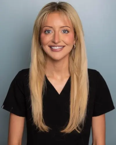 a woman with blonde hair wearing a black shirt