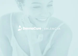 a woman smiling with her hand on her face