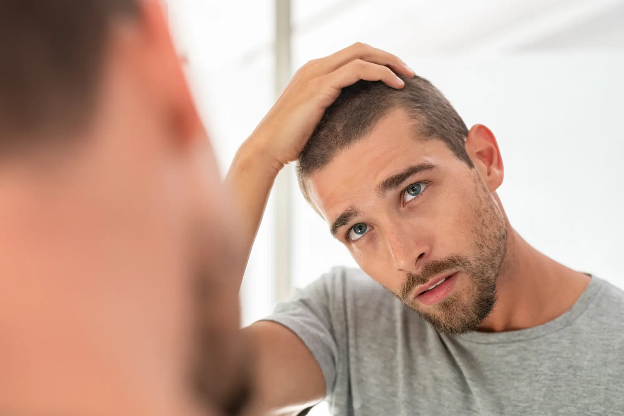 a man looking at himself in the mirror